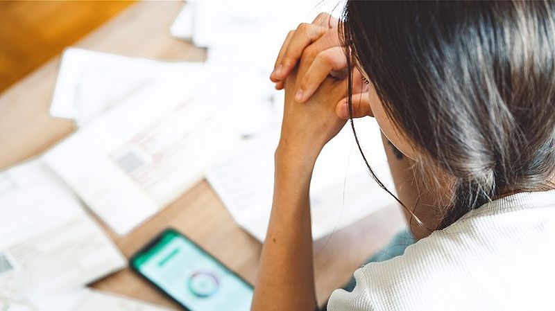 Distressed person looking over finances