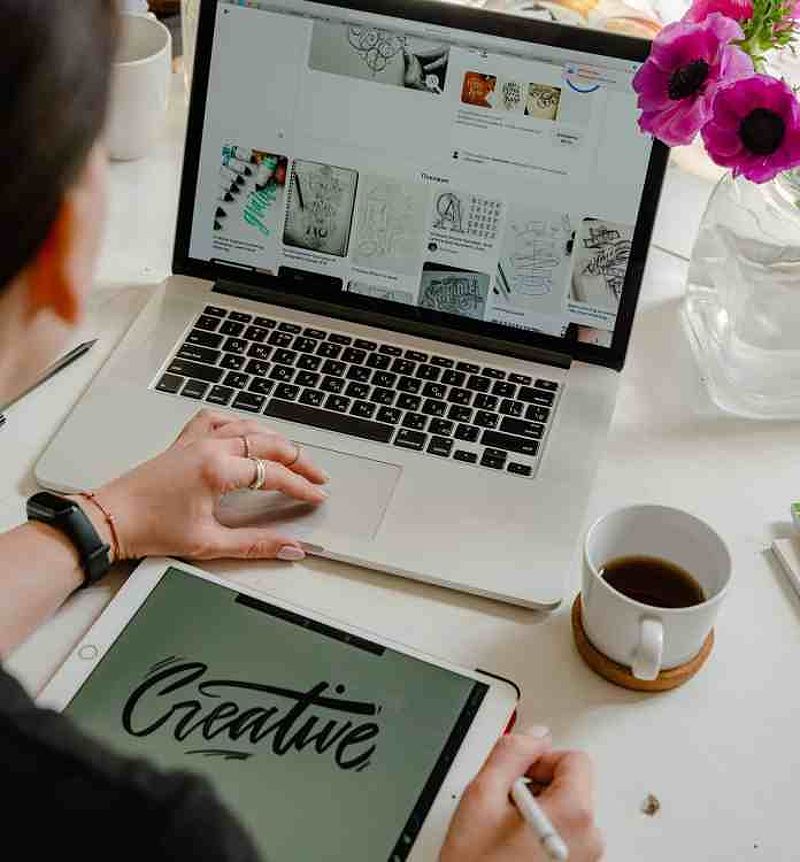 Person using macbook on table become a creative