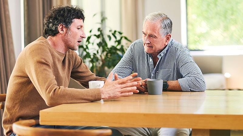 Two people talking over coffee